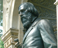 von Graefe holding a Helmholtz ophthalmoscope.